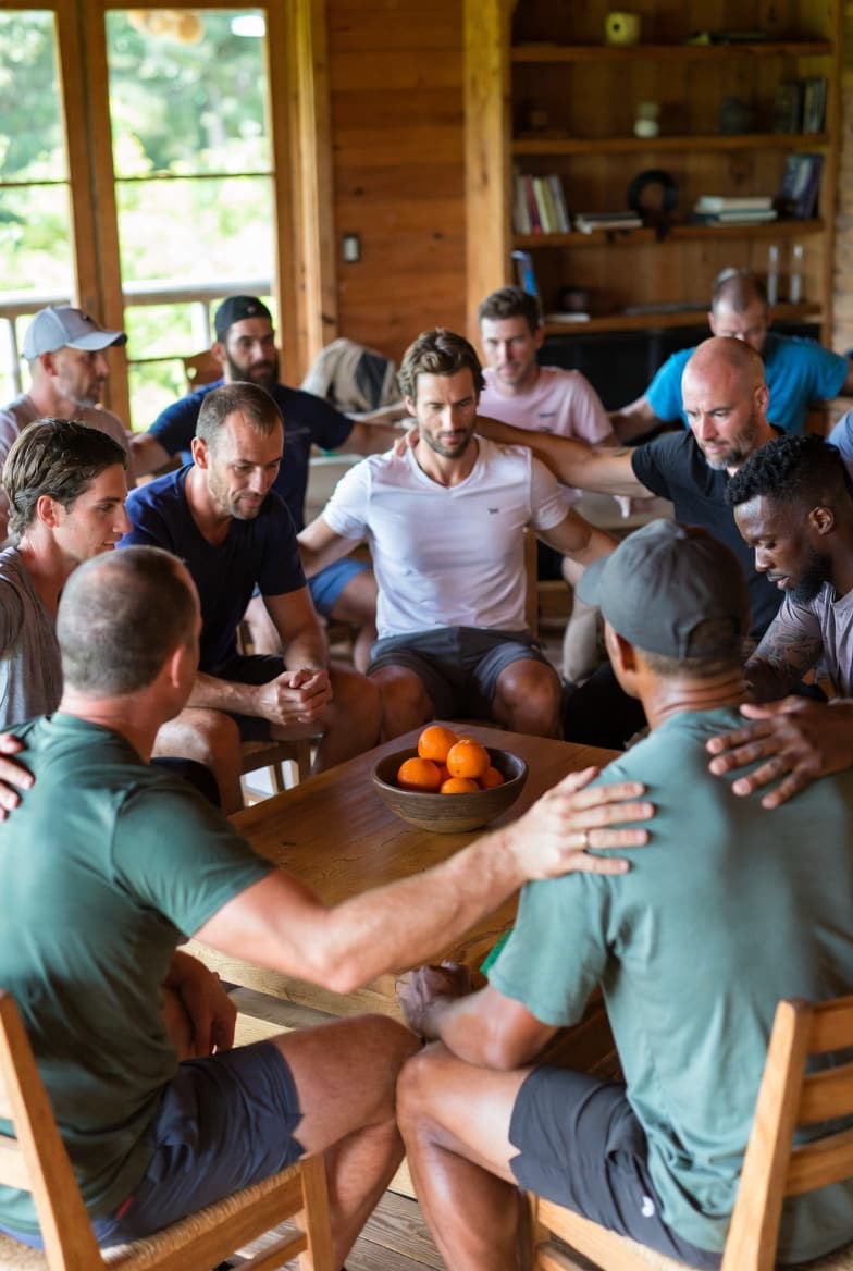 Men gathered in a lodge circle at The Heroes' Journey retreat